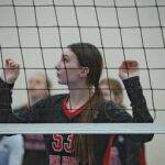 Young Woman Standing by the Net during a Volleyball Game
