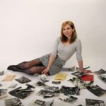 A women sitting on floor along with her past picture spread on floor